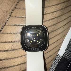 Fitbit Smartwatch with Black Face and Cream Band